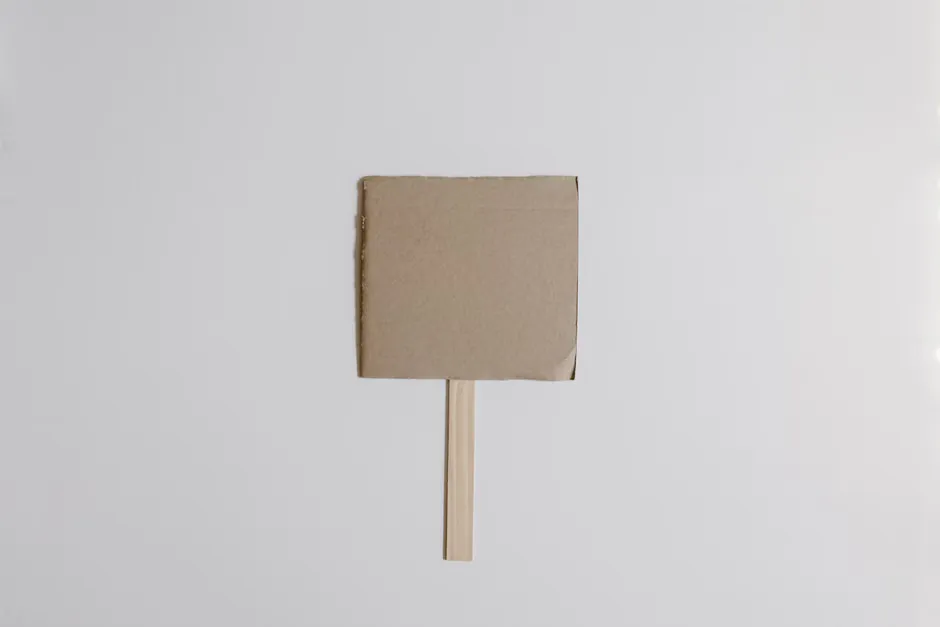Plain unbranded cardboard parcel on a hallway console table beside a set of house keys